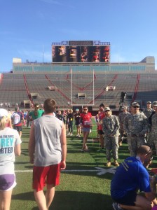 You are video taped as you enter Memorial Stadium. There are also all your adoring fans cheering you on from the stands! Or at least there are people.
